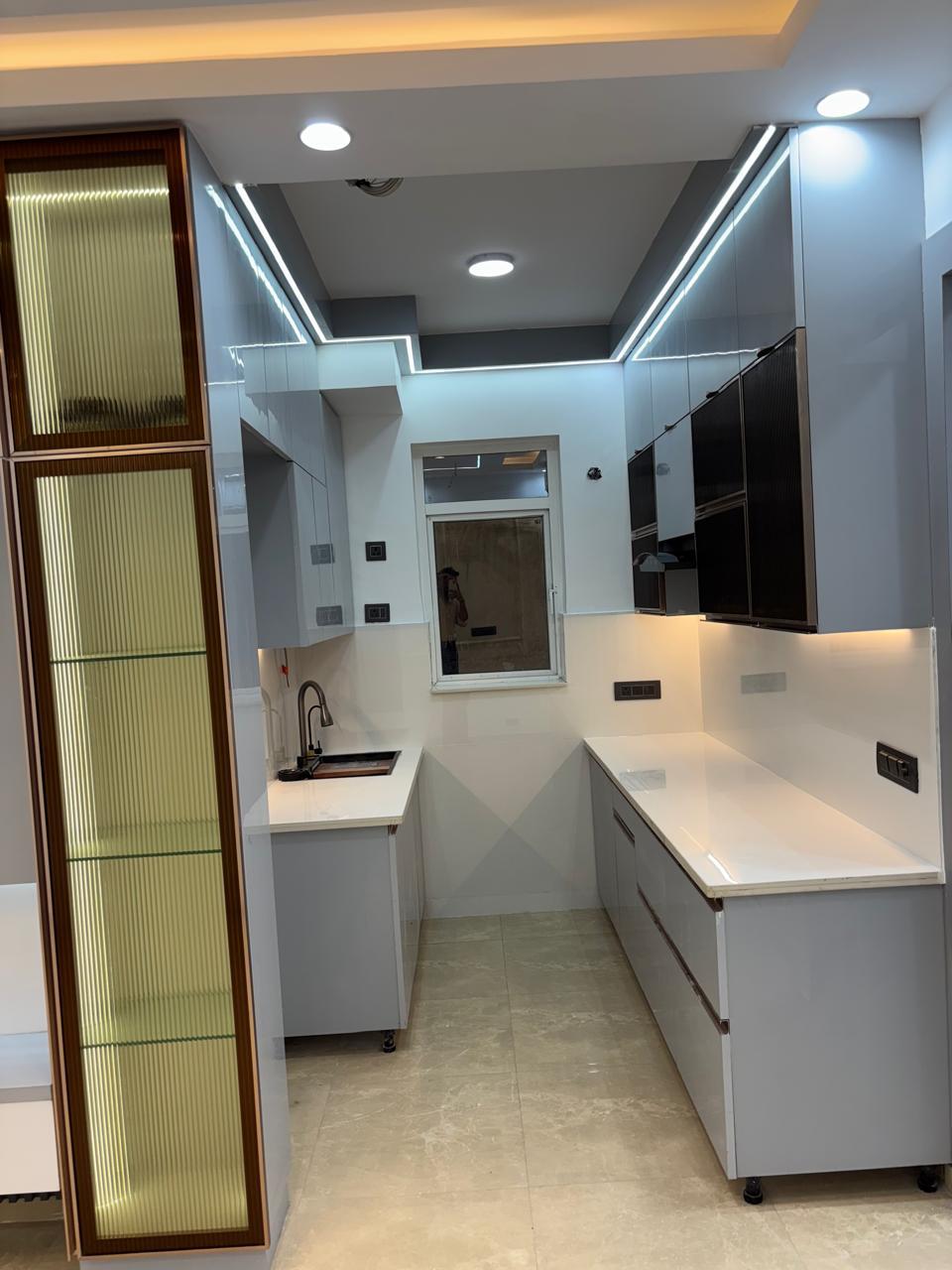 Modular kitchen with white and dark glass-shutter uppers