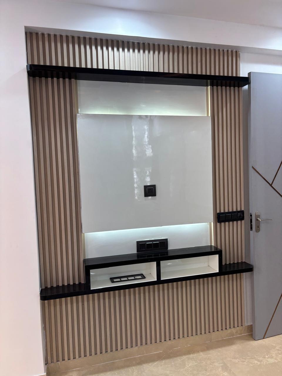 TV unit framed by a wood-slat wall panel