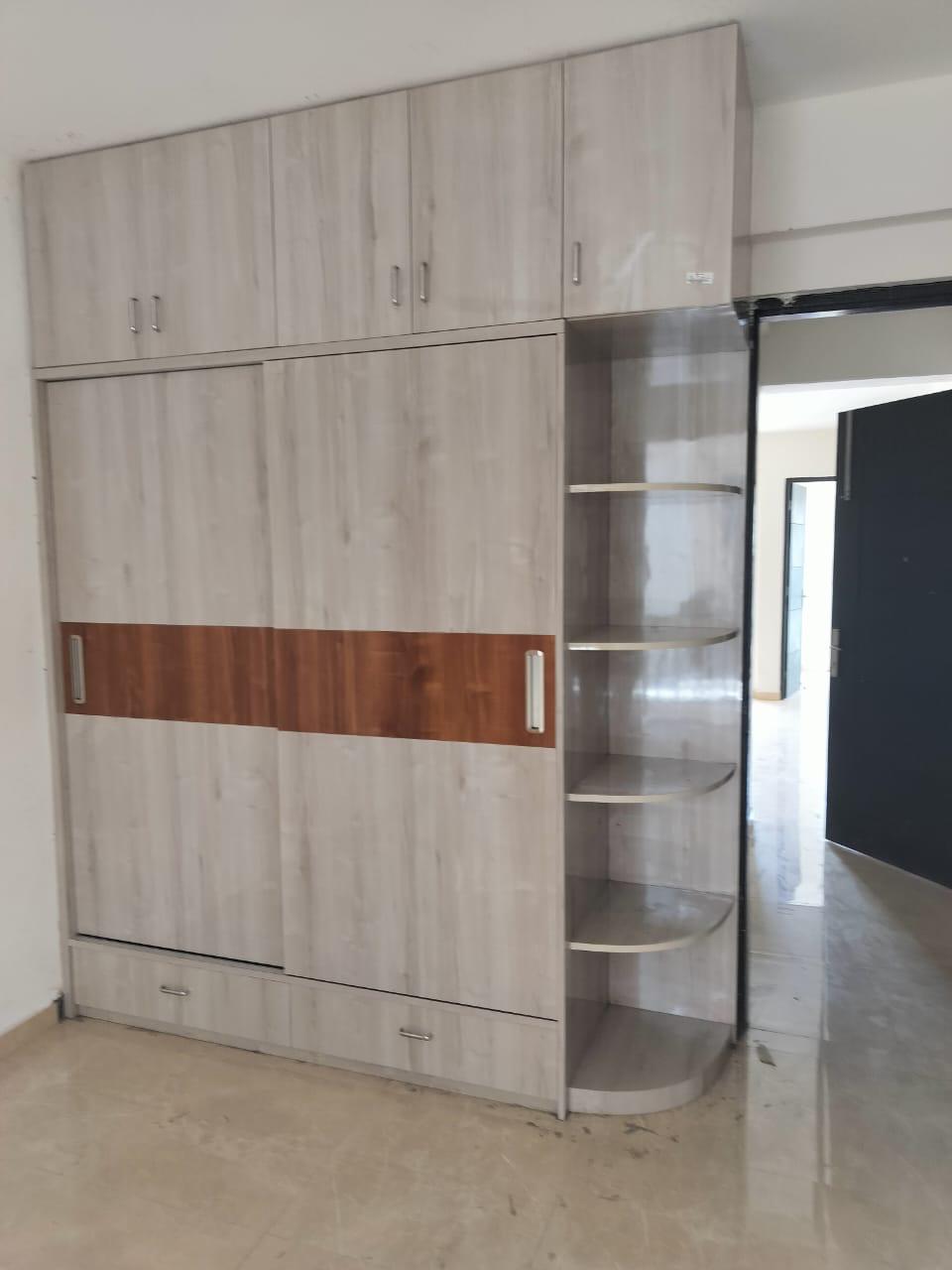 Wood-tone wardrobe with curved corner shelving