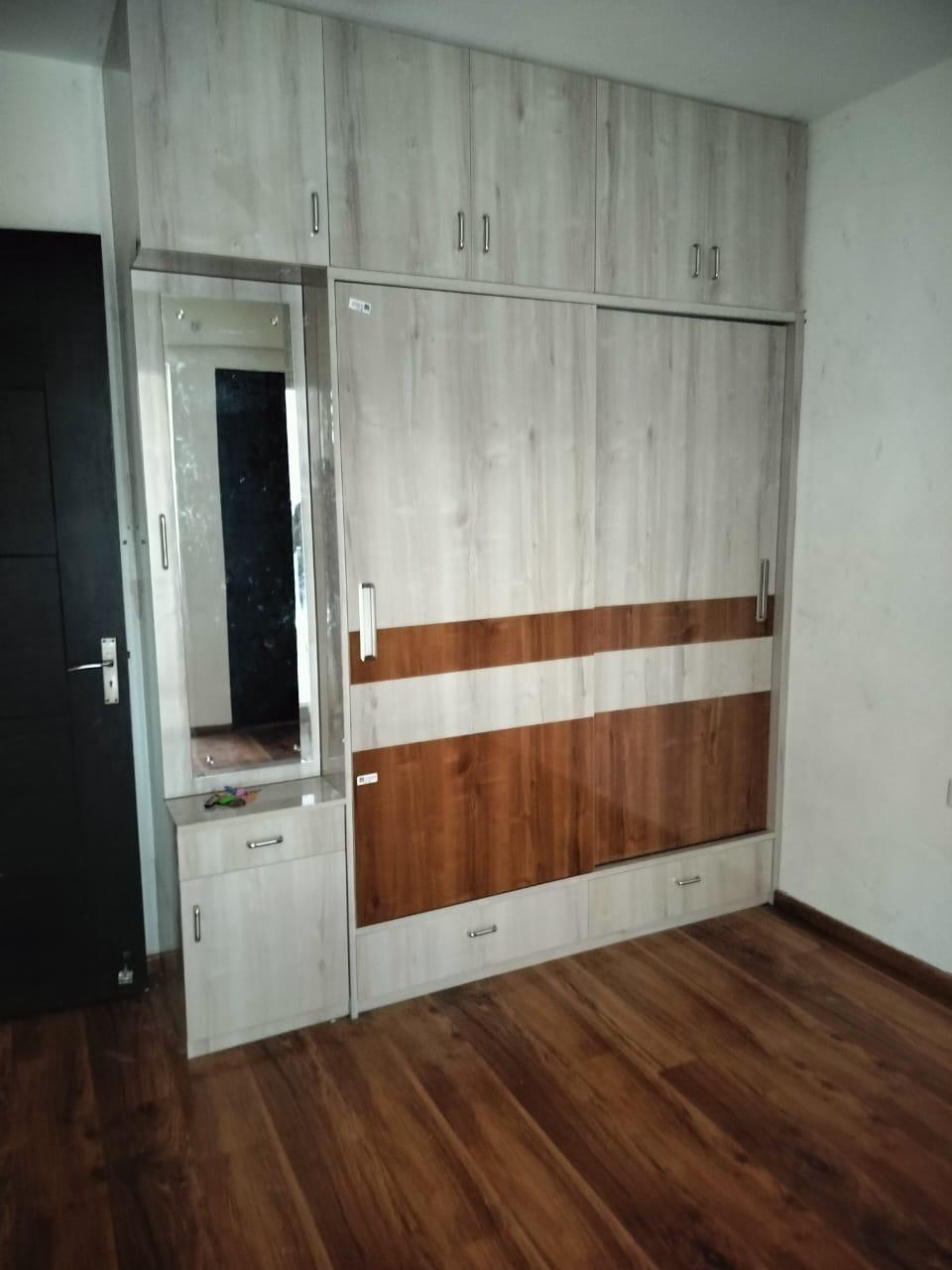 Wood-tone wardrobe with an integrated dressing mirror unit
