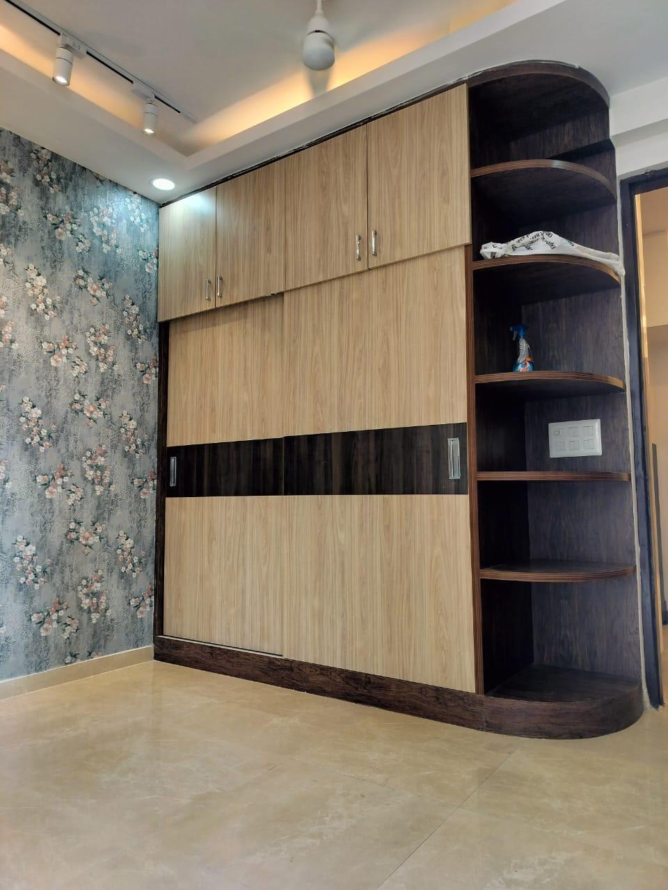 Wood-tone wardrobe against a floral accent wall